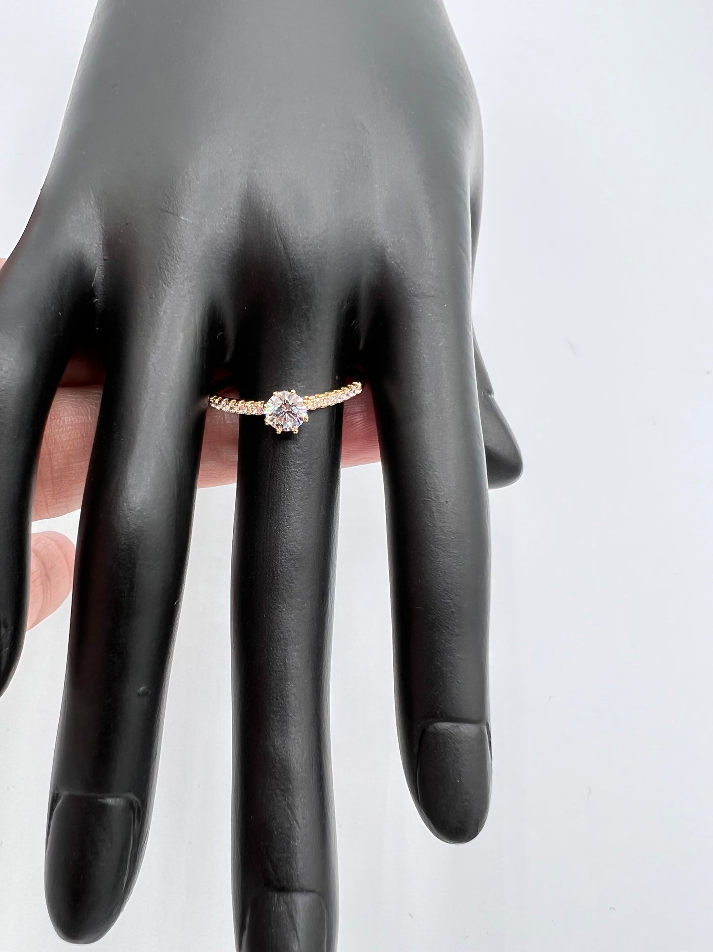 one big stone in the middle and cluster of cubic zirconia on the bandnon tarnish gold plated ring with