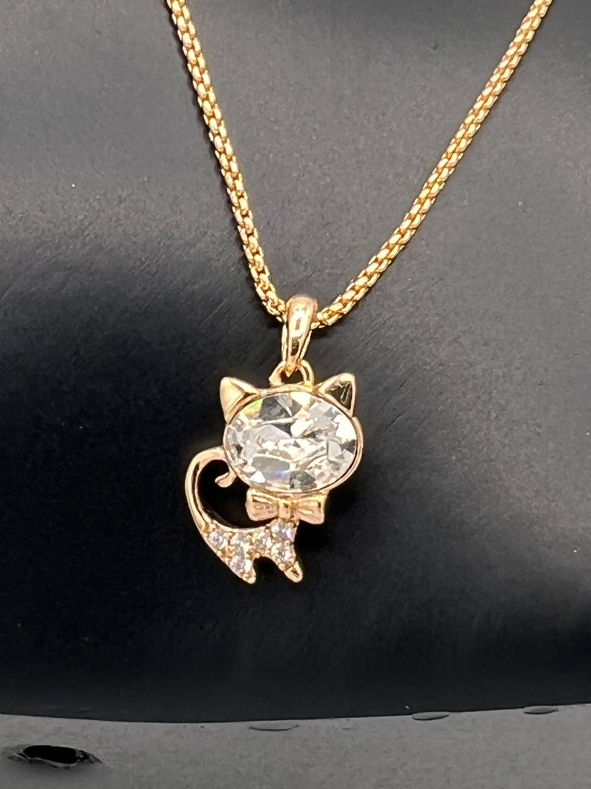 white and gold cat pendant with gold plated chain