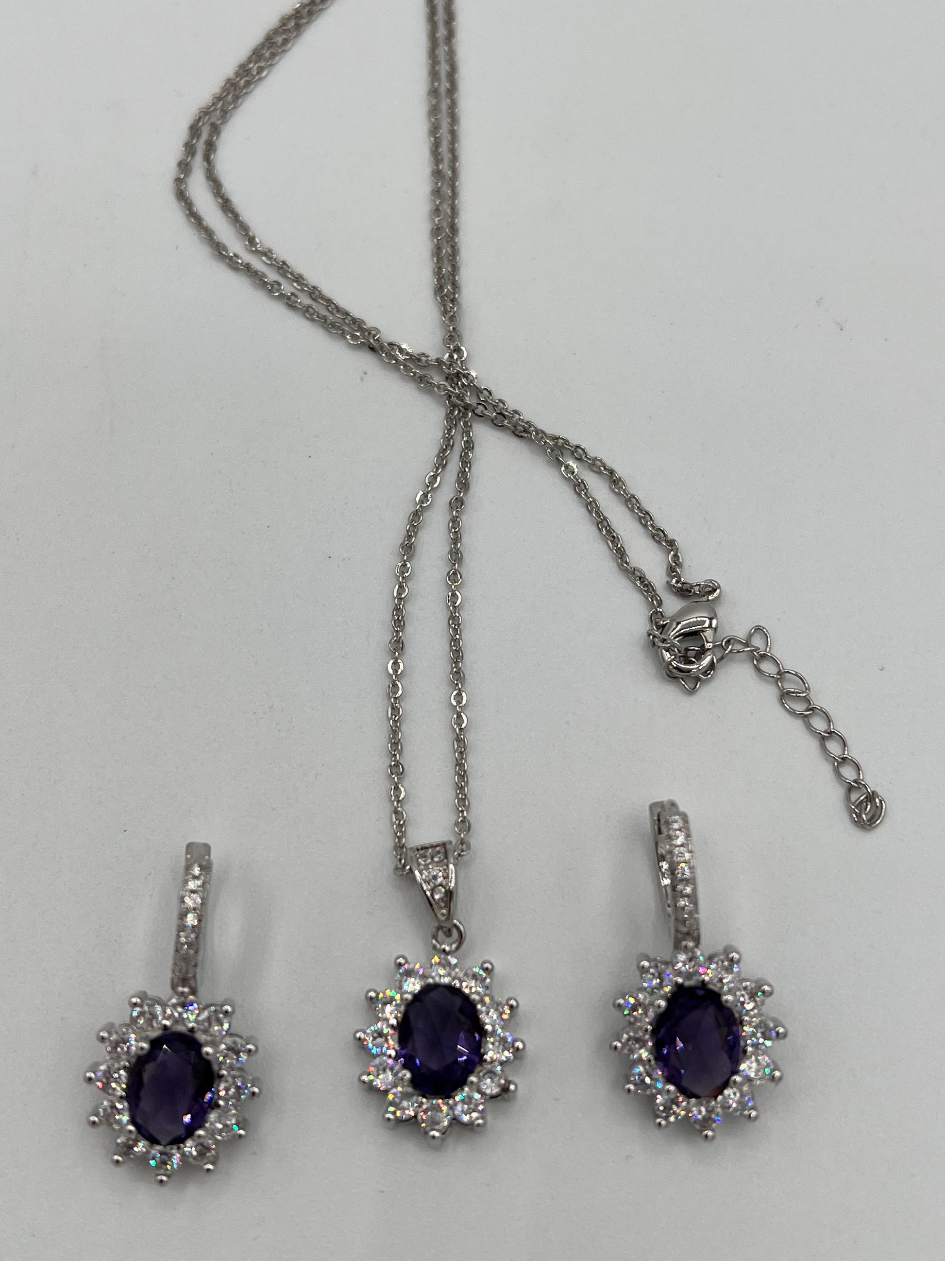 classic design earring and necklace set in Amethyst  color main oval zircon surrounding by white cubic zircons