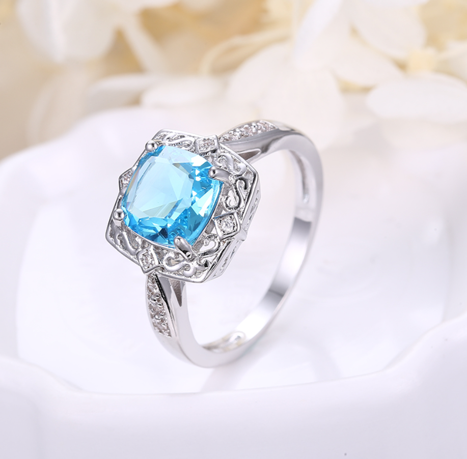 The blue square zircon is surrounding by solid silver design embellished with zircons For Women . nickel and lead free white gold plated AAA zircons 
